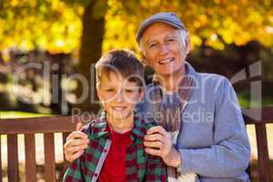 Grandfather sitting with grandson at park