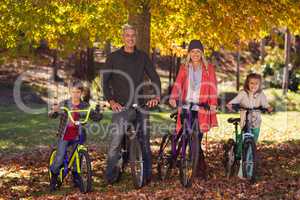 Happy family riding bicycles at park