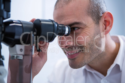 Optometrist looking through biomicroscope