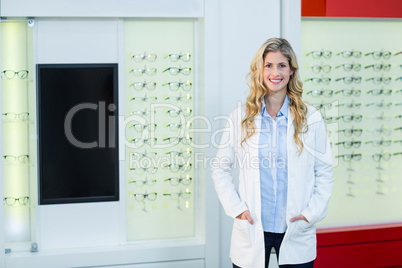 Beautiful optometrist standing in ophthalmology clinic