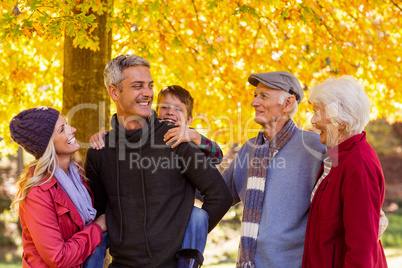 Happy multi-generation family standing at park