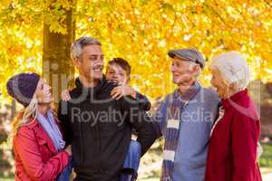 Happy multi-generation family standing at park