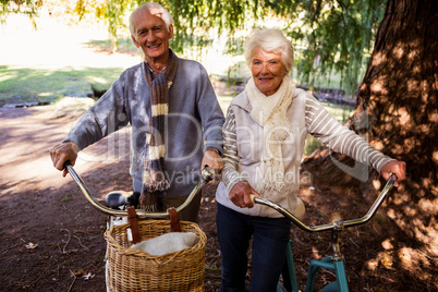 Senior couple holding their bike