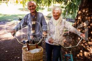 Senior couple holding their bike