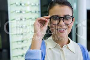 Smiling female customer trying spectacles