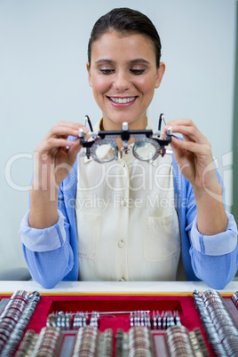 Optician looking at trial frame