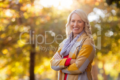 Portrait of young woman standing at park