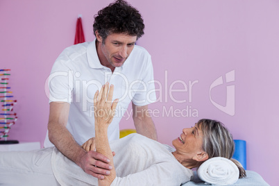 Physiotherapist massaging a senior womans hand