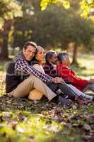 Smiling family relaxing at park