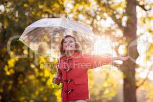Smiling girl with umbrella at park