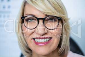 Beautiful woman wearing spectacles in optical store