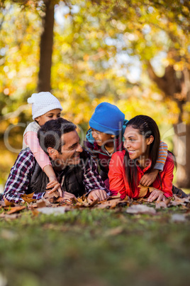 Cheerful family lying on field during autumn