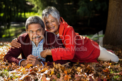 Couple resting on at park during autumn