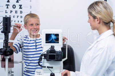 Optometrist interacting with young patient