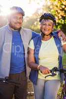 Portrait of mature couple holding cycling helmet