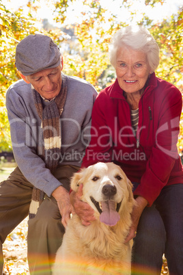 Portrait of elderly couple with their pet dog