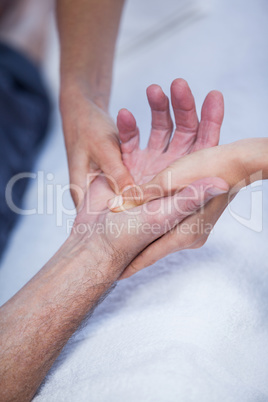 Physiotherapist giving hand massage to a patient