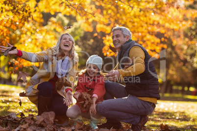 Joyful family at park during autumn