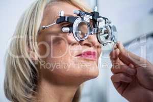 Optometrist examining female patient with messbrille