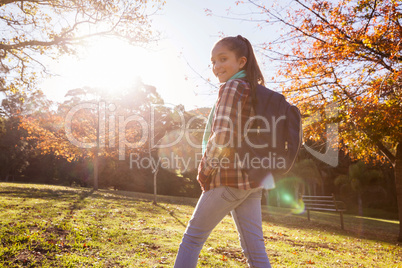 Portrait of smiling girl hiking at park