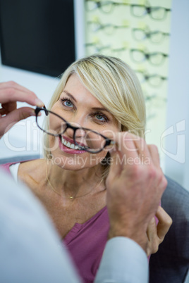 Optician consulting a customer about spectacles and frames