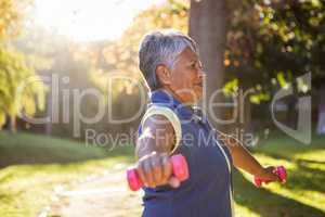 Woman exercising with dumbbell at park