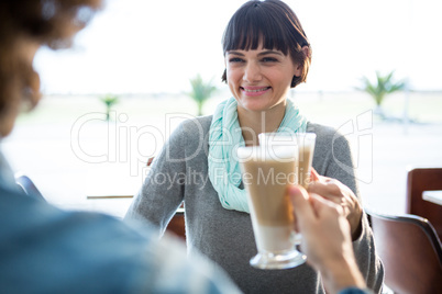 Couple toasting glass of cold coffee