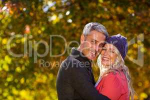 Portrait of couple hugging at park