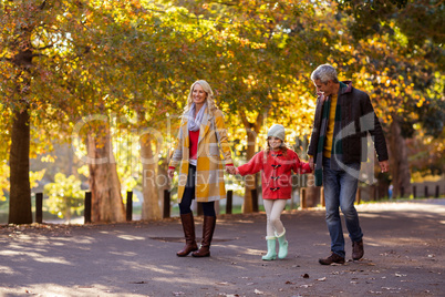 Girl walking with parents on road