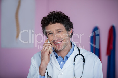 Portrait of physiotherapist talking on mobile phone