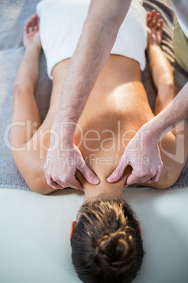 Physiotherapist giving physical therapy to the neck of a female