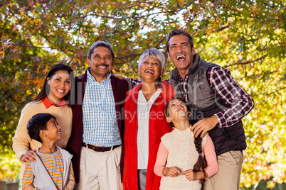 Cheerful multi-generation family laughing at park