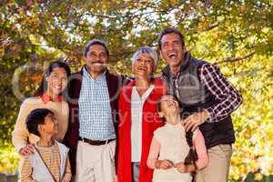 Cheerful multi-generation family laughing at park