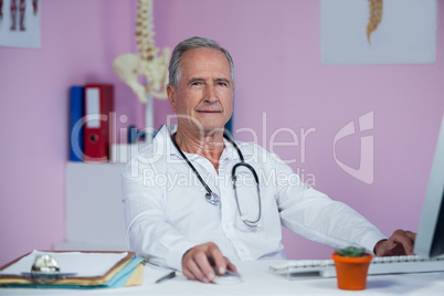 Physiotherapist working on computer