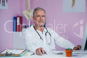 Physiotherapist working on computer