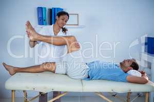 Physiotherapist giving leg massage to a patient