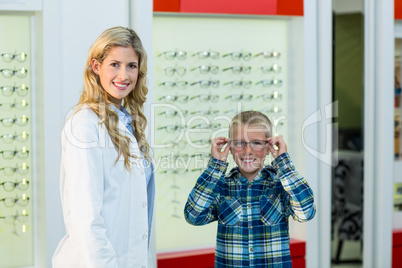 Portrait of female optometrist and young patient