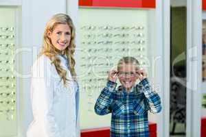 Portrait of female optometrist and young patient