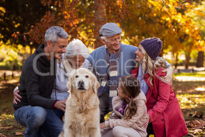 Happy family with dog at park during autumn