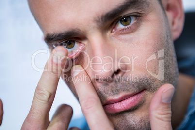 Man applying contact lens