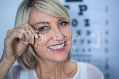 Female patient looking through magnifying glass