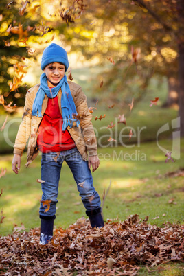 Portrait of smiling boy with autumn leaves