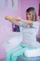 Senior woman exercising with exercise band