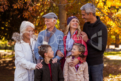 Happy multi-generation family standing at park