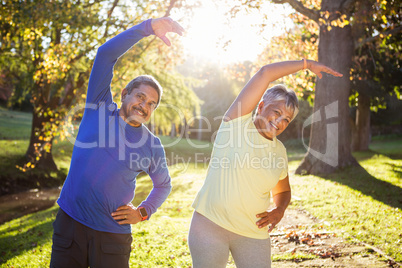 Mature couple exercising at park