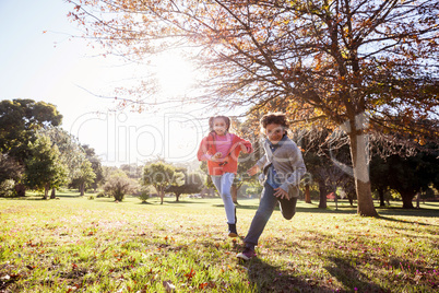 Smiling children running in park