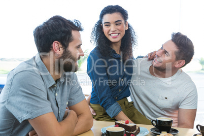 Friends interacting with each other in coffee shop