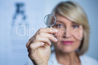 Female optometrist holding magnifying glass