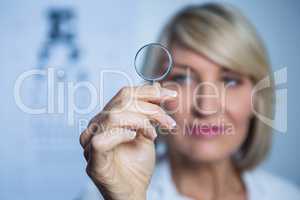 Female optometrist holding magnifying glass