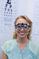 Female patient looking through messbrille during eye examination